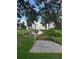 Scenic view of the lake from the backyard with lush landscaping and a dock at 32511 Purdum Ave, Leesburg, FL 34788