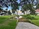Scenic backyard view with lush greenery leading to a serene lake and private dock perfect for relaxation at 32511 Purdum Ave, Leesburg, FL 34788