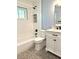 Modern bathroom with a white vanity, marble countertop, and a stylish tiled shower at 32511 Purdum Ave, Leesburg, FL 34788