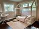 Charming bedroom with hardwood floors, large windows, a unique bed frame, and neutral pink tones at 32511 Purdum Ave, Leesburg, FL 34788