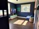 A modern bedroom space featuring a TV, neon Minecraft sign, and natural light at 32511 Purdum Ave, Leesburg, FL 34788