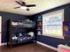 Charming bedroom with a bunk bed, ceiling fan, and a large window offering ample natural light at 32511 Purdum Ave, Leesburg, FL 34788