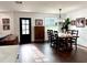 Dining room with a wooden table, chandelier, modern decor and a view of the living area at 32511 Purdum Ave, Leesburg, FL 34788