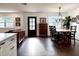 Dining room with a wooden table, chandelier, modern decor and a view of the living area at 32511 Purdum Ave, Leesburg, FL 34788