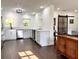 Bright kitchen with stainless steel appliances, white cabinets, backsplash, and an adjoining living area at 32511 Purdum Ave, Leesburg, FL 34788
