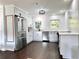 Modern kitchen with stainless steel appliances, white cabinetry, and beautiful backsplash with natural lighting at 32511 Purdum Ave, Leesburg, FL 34788