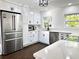 Elegant, updated kitchen featuring stainless steel appliances, white cabinets, and island at 32511 Purdum Ave, Leesburg, FL 34788