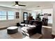 Cozy living room with modern furniture, hardwood floors, natural light, and an adjoining dining area at 32511 Purdum Ave, Leesburg, FL 34788