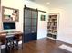 Well-lit office space featuring a desk, computer, sliding door and built-in bookcase at 32511 Purdum Ave, Leesburg, FL 34788