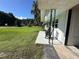 Cozy porch featuring decorative ironwork and black rocking chairs, overlooking a well-manicured lawn at 32511 Purdum Ave, Leesburg, FL 34788
