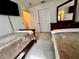 Cozy bedroom featuring twin beds, built-in closet, dresser, and comfortable carpeting at 327 Bentwood Dr, Leesburg, FL 34748