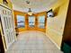 Bright breakfast nook with three windows, a ceiling fan, and tile flooring at 327 Bentwood Dr, Leesburg, FL 34748