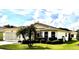 Inviting single-story home with well-manicured lawn and lush landscaping, offering great curb appeal at 327 Bentwood Dr, Leesburg, FL 34748