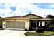Charming single-story home with a well-maintained lawn, screened garage, and cozy front entrance at 327 Bentwood Dr, Leesburg, FL 34748