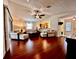 Bright living room features hardwood floors, comfortable seating, and an open layout with backyard access at 327 Bentwood Dr, Leesburg, FL 34748