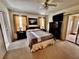 Serene main bedroom featuring a ceiling fan, neutral carpeting, and slider to the backyard at 327 Bentwood Dr, Leesburg, FL 34748
