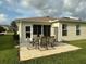 Outdoor patio with dining set, perfect for entertaining guests or enjoying a quiet meal at 327 Bentwood Dr, Leesburg, FL 34748