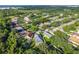 Aerial view of a lush neighborhood with mature trees and well-maintained homes near the waterfront at 33441 Irongate Dr, Leesburg, FL 34788