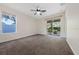 Bright bedroom with large windows, sliding glass doors to the outside, and neutral carpet flooring at 33441 Irongate Dr, Leesburg, FL 34788