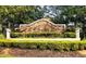 Stone community entrance sign surrounded by manicured greenery and landscaping at 33441 Irongate Dr, Leesburg, FL 34788