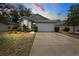 Charming single-story home featuring a well-manicured lawn and an attached two-car garage at 33441 Irongate Dr, Leesburg, FL 34788