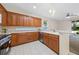 Well-lit kitchen boasting ample counter space, stainless steel appliances, and wooden cabinetry at 33441 Irongate Dr, Leesburg, FL 34788