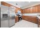 Bright kitchen showcasing stainless steel appliances and beautiful wood cabinetry at 33441 Irongate Dr, Leesburg, FL 34788
