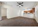 Open-concept living room with neutral carpet flowing into an eat-in kitchen and stainless steel appliances at 33441 Irongate Dr, Leesburg, FL 34788