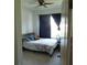 A bright bedroom featuring a full-sized bed, window, and workspace in a cozy and inviting setting at 418 Winter Bliss Ln, Mount Dora, FL 32757