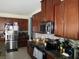 Elegant kitchen featuring stainless steel appliances, granite counters, and ample dark wood cabinetry at 418 Winter Bliss Ln, Mount Dora, FL 32757