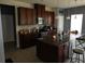 Stylish kitchen offering dark wooden cabinetry, granite countertops, stainless appliances, and a center island at 418 Winter Bliss Ln, Mount Dora, FL 32757