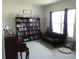 Features a comfortable living room area with a large bookshelf, piano, and natural light at 418 Winter Bliss Ln, Mount Dora, FL 32757