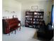 Features a bookshelf, piano, and comfortable sofa in this inviting living room space at 418 Winter Bliss Ln, Mount Dora, FL 32757