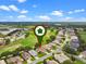 A view of a neighborhood with a golf course and a lake in the background on a bright sunny day at 4909 Kelso St, Leesburg, FL 34748