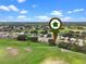 Aerial view shows a home in a beautiful neighborhood near golf course, under a sunny sky at 4909 Kelso St, Leesburg, FL 34748