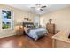 Spacious bedroom featuring hardwood floors and a ceiling fan at 4909 Kelso St, Leesburg, FL 34748