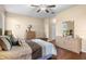 Cozy bedroom with natural light, wood floors, ceiling fan, and dresser at 4909 Kelso St, Leesburg, FL 34748