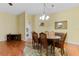 Dining room features hardwood floors, chandelier lighting and a beautiful rug at 4909 Kelso St, Leesburg, FL 34748