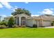 Charming single Gathering home with an arched entry, three car garage, and well manicured landscaping at 4909 Kelso St, Leesburg, FL 34748