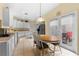 Eat in kitchen featuring tile floors, white cabinets, and stainless steel appliances at 4909 Kelso St, Leesburg, FL 34748