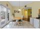 Eat in kitchen featuring arched doorway and door access to a screened in patio at 4909 Kelso St, Leesburg, FL 34748