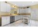 Bright kitchen with white cabinets, stainless steel appliances, and a kitchen island at 4909 Kelso St, Leesburg, FL 34748