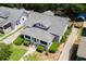 Aerial shot of home with gray shingled roof, screened in front porch, and mature landscaping at 501 Washington Ave, Eustis, FL 32726