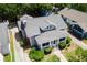 Aerial view of home with neutral gray roof, screened in front porch, and mature trees at 501 Washington Ave, Eustis, FL 32726