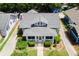 An aerial view of the charming bungalow with manicured lawn and a gray roof at 501 Washington Ave, Eustis, FL 32726
