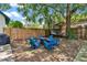 Backyard featuring large shade tree, fire pit, six adirondack chairs, and hammock at 501 Washington Ave, Eustis, FL 32726