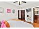 Comfortable bedroom featuring hardwood floors, a large window, and access to an en-suite bathroom at 501 Washington Ave, Eustis, FL 32726
