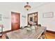 View of dining room with modern chandelier and hardwood floors, and glimpses of living room and hallway at 501 Washington Ave, Eustis, FL 32726