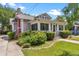 Charming bungalow with a screened front porch, red chimney, and manicured landscaping at 501 Washington Ave, Eustis, FL 32726