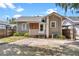 Charming home with neutral siding, front yard with mature landscaping, and private driveway at 501 Washington Ave, Eustis, FL 32726